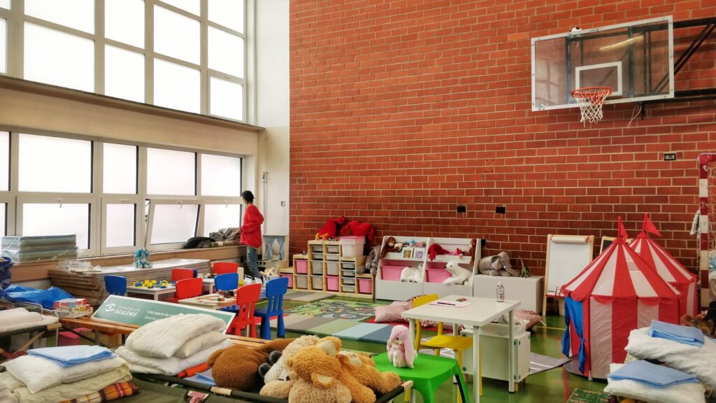 Volunteer looking out the window at a pop up daycare in a refugee centre in Zamość